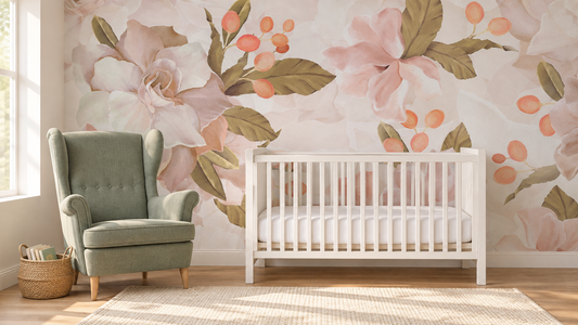 Floral nursery concept with oversized pink blossoms, olive leaves, a white crib and a sage green reading chair.